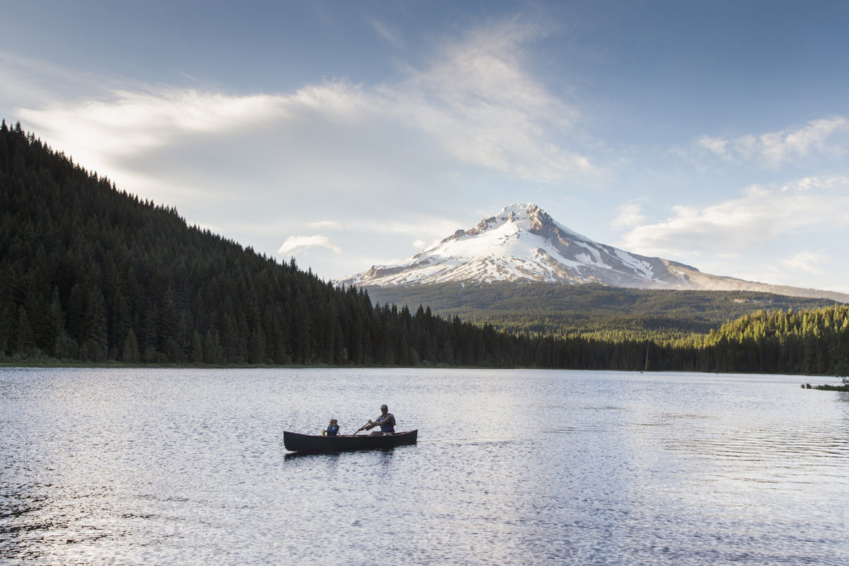 People canoeing on Trillium Lake with Mt. Hood in the background